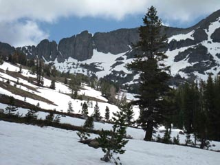 Coming out of the trees past the footbridge, we see the rock ridge face between Winnemuca Lake and Round Top