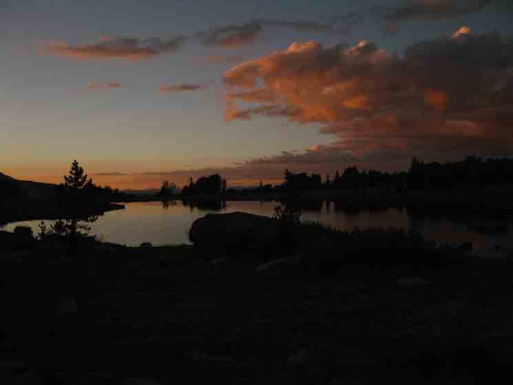 Sunset over the lake between Evelyn and Ireland Lakes near Vogelsang Hgih Sierra Camp.