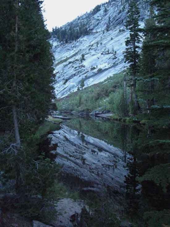 Merced River exits lake through a narrow granite channel.