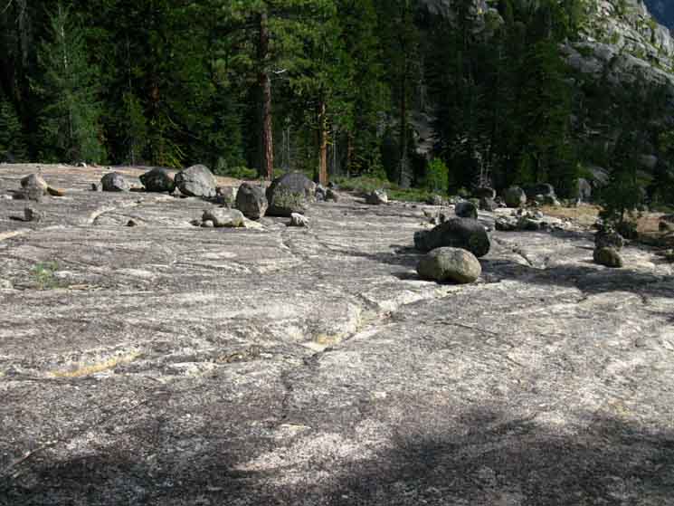 Erratics, random boulders dropped by receeding Glacier decorate our great granite slab.