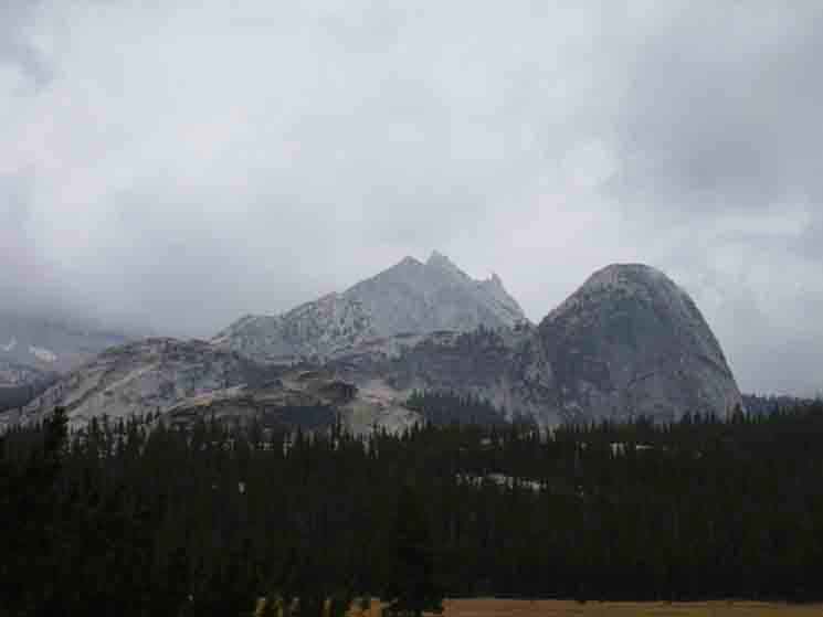 Cathedral Peak and Fairview Dome under clouds.