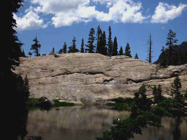 Granite slab composes south bank of central Seavy Pass Pond in Yosemite along the Pacific Crest Trail.