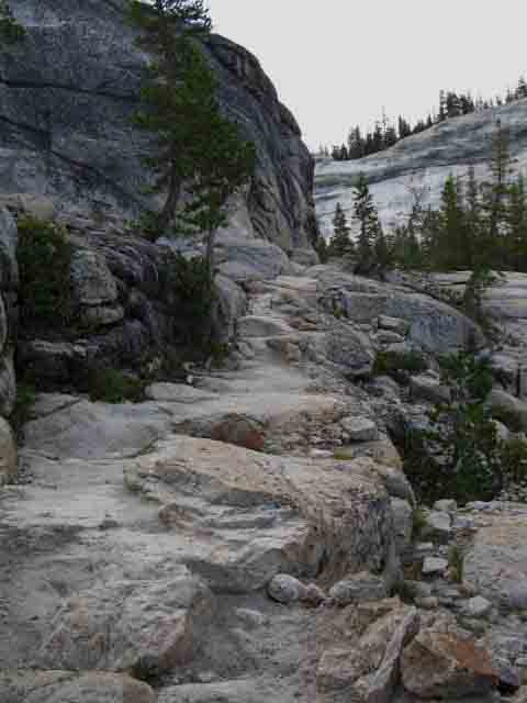 Trail on rock above bend in Tuolumne River.
