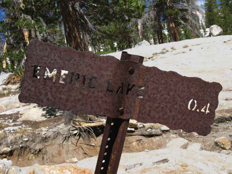 Trail sign specifying miles to Emeric Lake.
