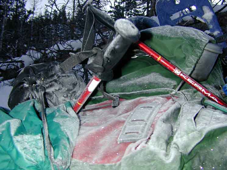 Frosty pack wedged under ski sticks